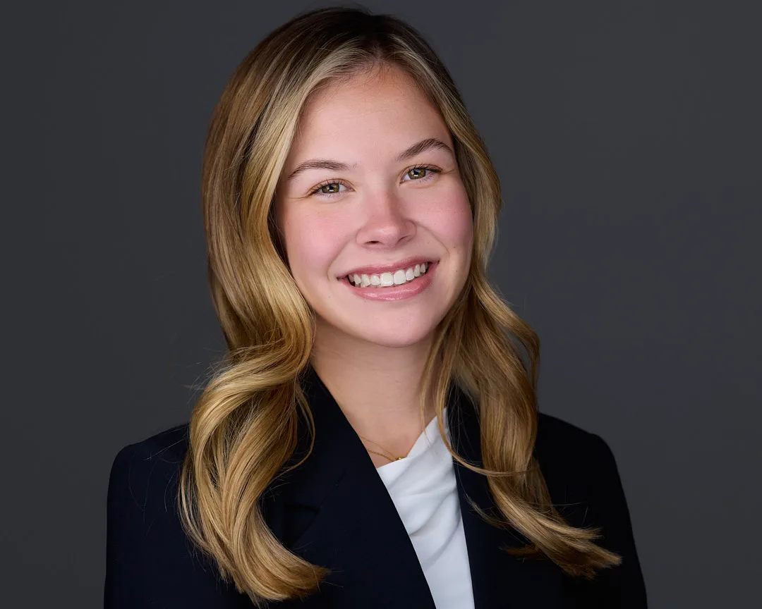 Authentic professional corporate headshot demonstrating natural warmth and confidence