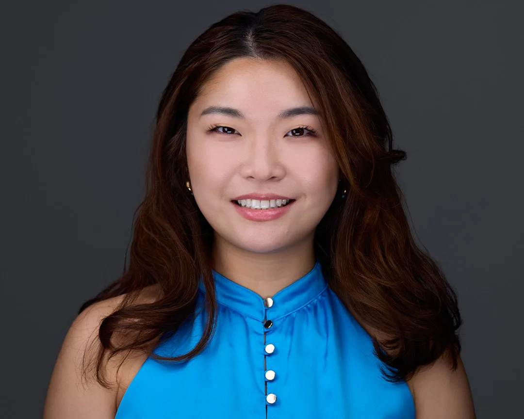 Executive portrait with professional presence and refined styling against neutral backdrop