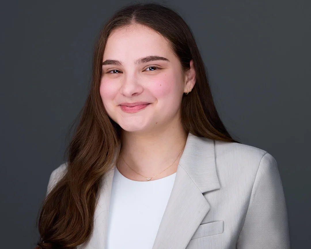 Professional corporate headshot with confident expression and polished business styling