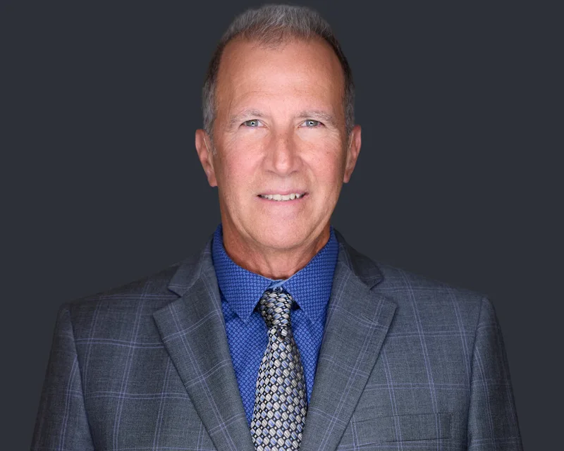 Real estate agent headshot from a brokerage team session, with lighting and styling consistent across the roster